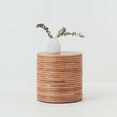 Front view of the Palma Rattan Round Side Table with natural finish and sculptural coiled design